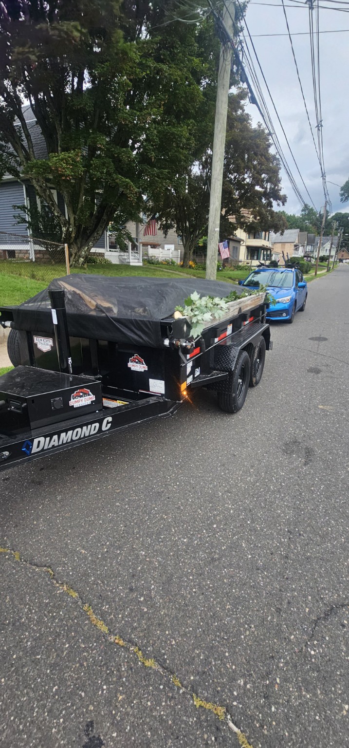 Diamond C Dumpy trailer secured with a tarp after a yard debris job